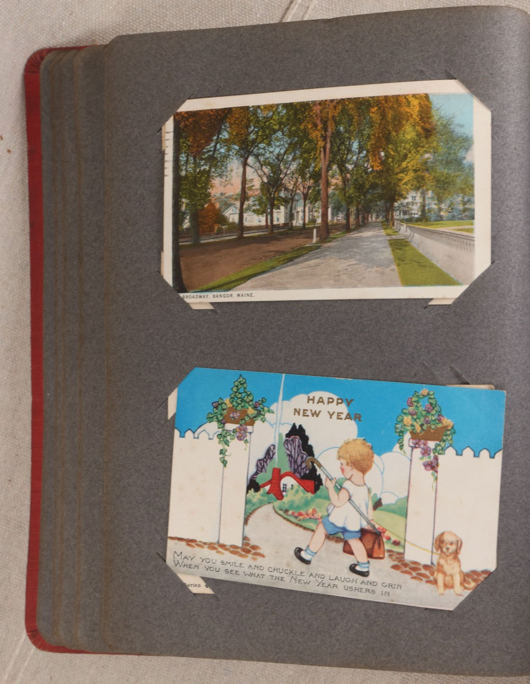 Lot 054 - Antique Postcard Album With Red Cover Containing Approximately 150 Antique And Vintage Postcards, New England, Holidays Including Christmas And Easter, Domestic, And International Subjects