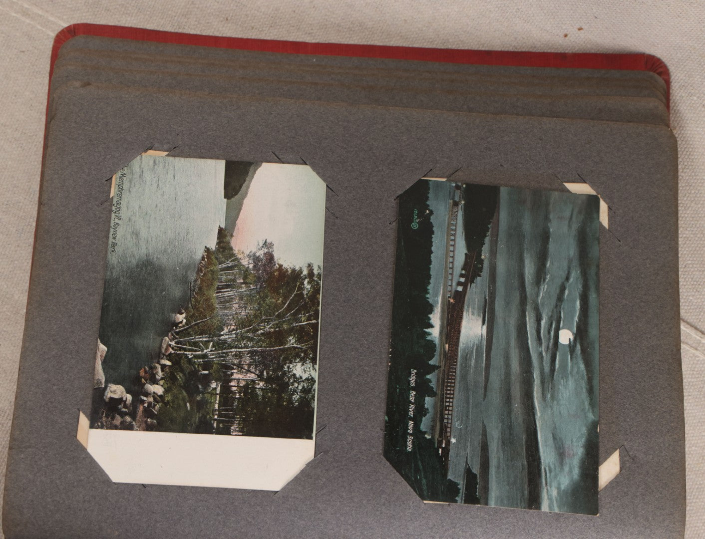 Lot 054 - Antique Postcard Album With Red Cover Containing Approximately 150 Antique And Vintage Postcards, New England, Holidays Including Christmas And Easter, Domestic, And International Subjects