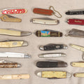 Lot 056 - Grouping Of 21 Vintage Pocket Knives Including Coors And Asten Felts Advertising Knives, Yellowstone Park And U.S. Capitol Washington D.C. Souvenir Knives, And Asian Bone Letter Opener