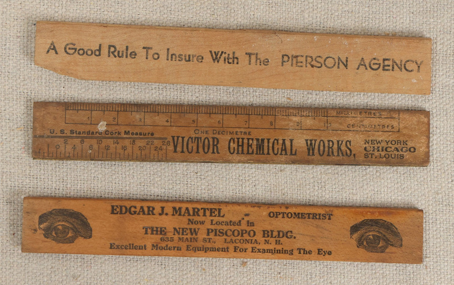 Lot 063 - Grouping Of 11 Vintage Advertising Wood And Plastic Rulers Including Edgar J. Martel Optometrist With Eye Graphics, Brown & Saltmarsh, Victor Phosphate Baking Powder, And More