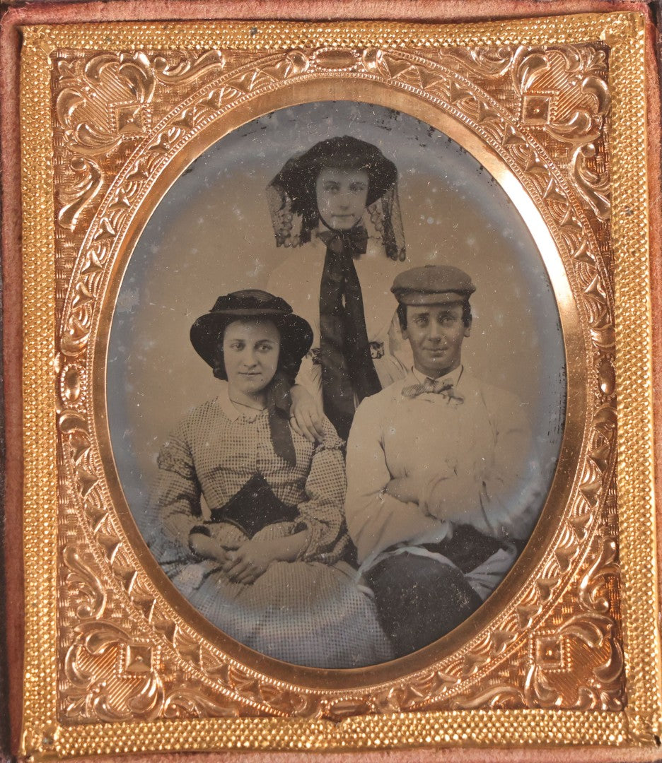 Lot 073 - Antique 1/6th Plate Ambrotype Photograph, Portrait Of Three Young People In Hats, Including Smiling Man, In Half Leatherette Case
