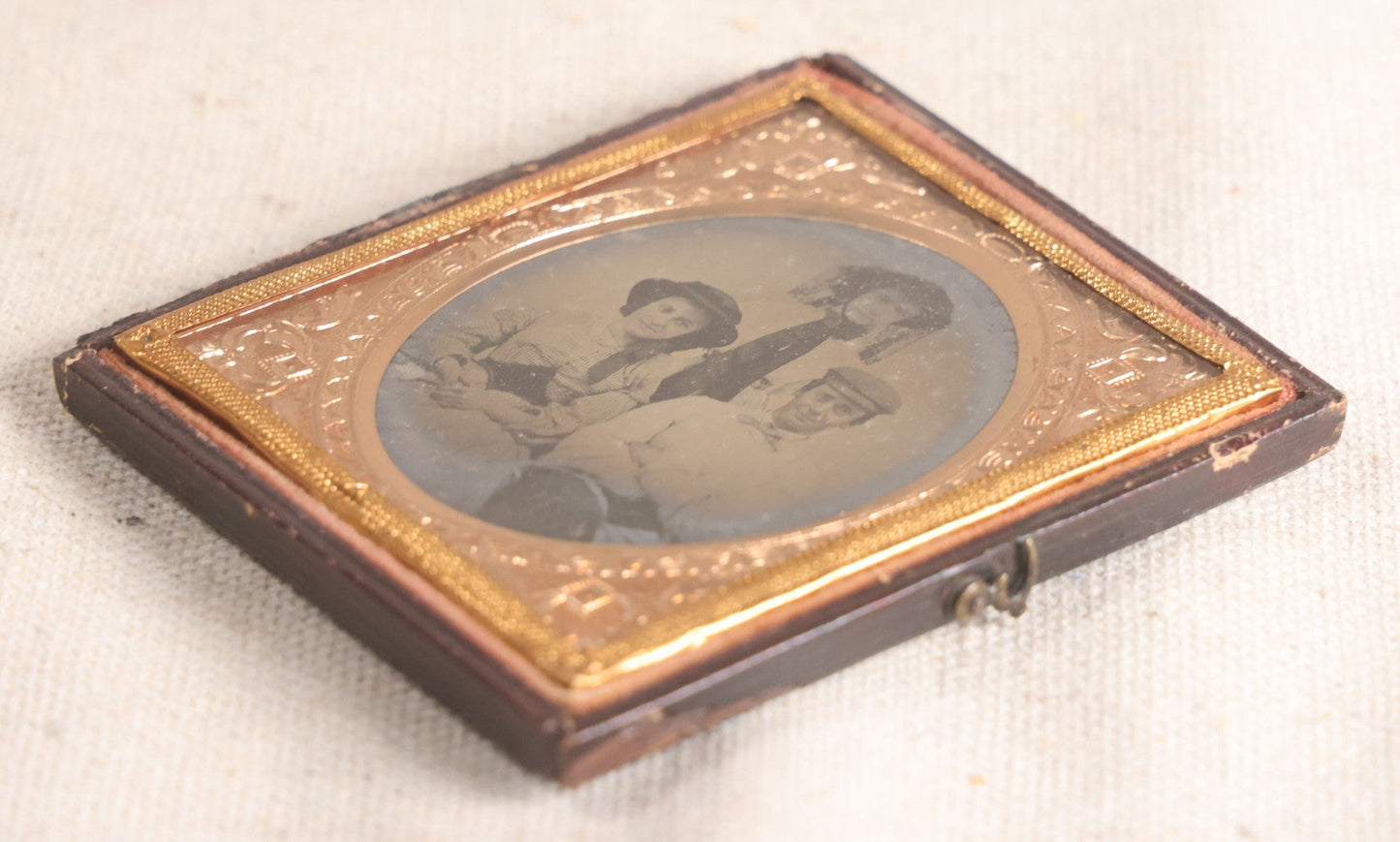 Lot 073 - Antique 1/6th Plate Ambrotype Photograph, Portrait Of Three Young People In Hats, Including Smiling Man, In Half Leatherette Case
