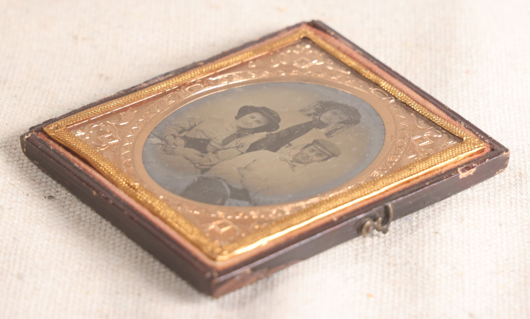 Lot 073 - Antique 1/6th Plate Ambrotype Photograph, Portrait Of Three Young People In Hats, Including Smiling Man, In Half Leatherette Case