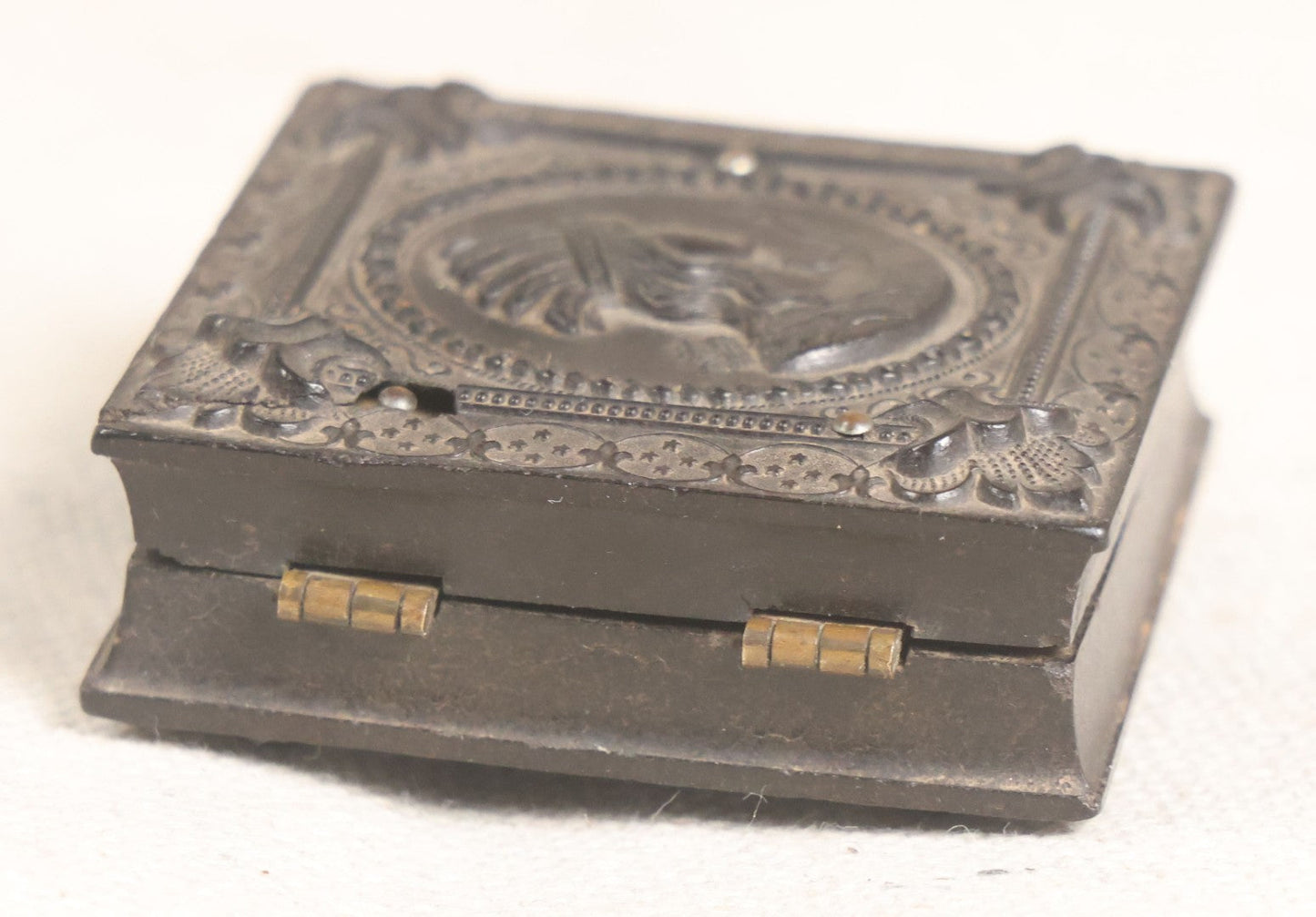 Lot 076 - Antique Thermoplastic Union Case With Native American Profile Bust And Star Border Design, Containing A 1/6th Plate Ambrotype Photograph Of A Young Man, Holmes, Booth & Haydens Label