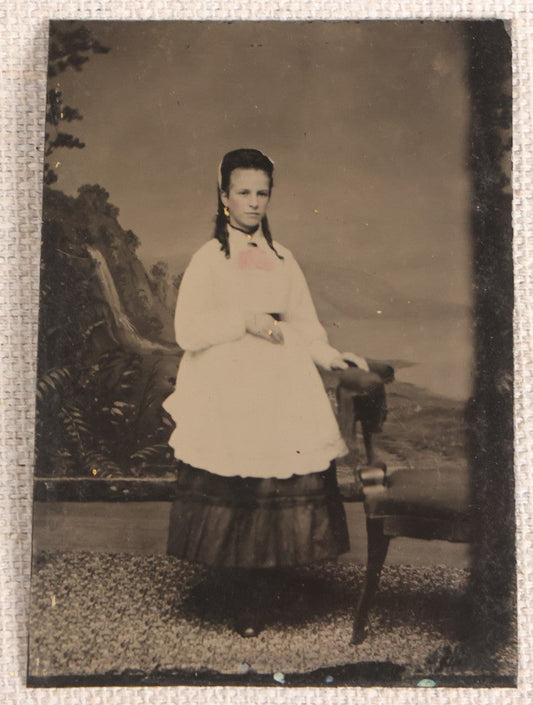 Lot 080 - Antique Tintype Photograph, Full-Length Portrait Of A Young Woman Who Appears To Be Pregnant In White Apron With Hand-Tinted Pink Bow