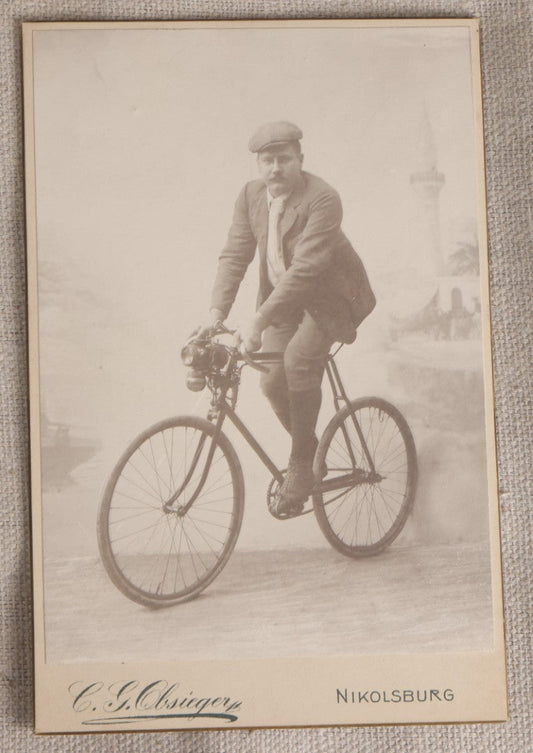 Lot 087 - Antique Cabinet Card Photograph Of A Man On A Bicycle, Photographed By C. G. Obsieger, Nikolsburg