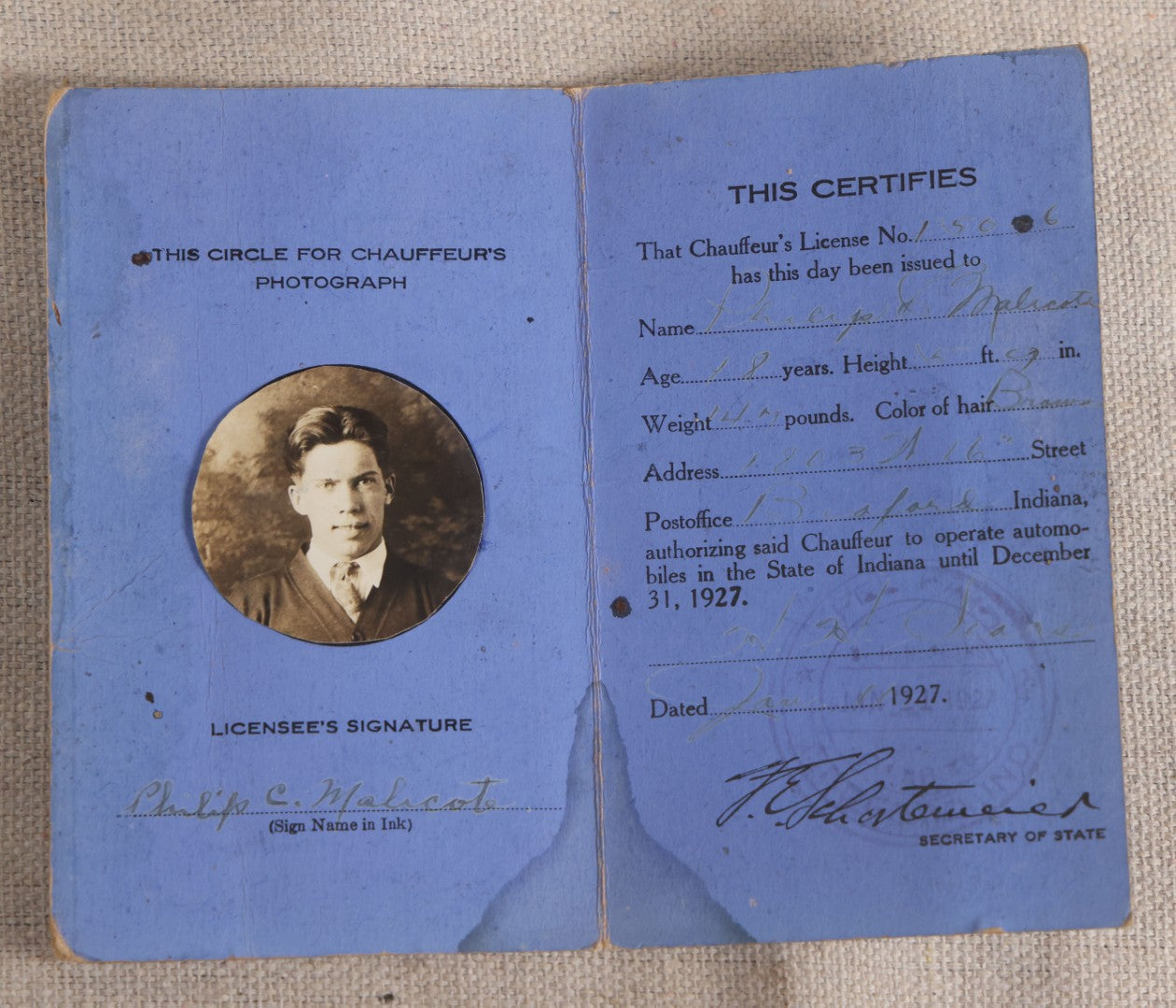 Lot 092 - Vintage 1927 Indiana Chauffeur's License With Circle-Cut Photograph Of Philip C. Malcote, Facsimile Signature Of F. E. Schortemeier, Secretary Of State