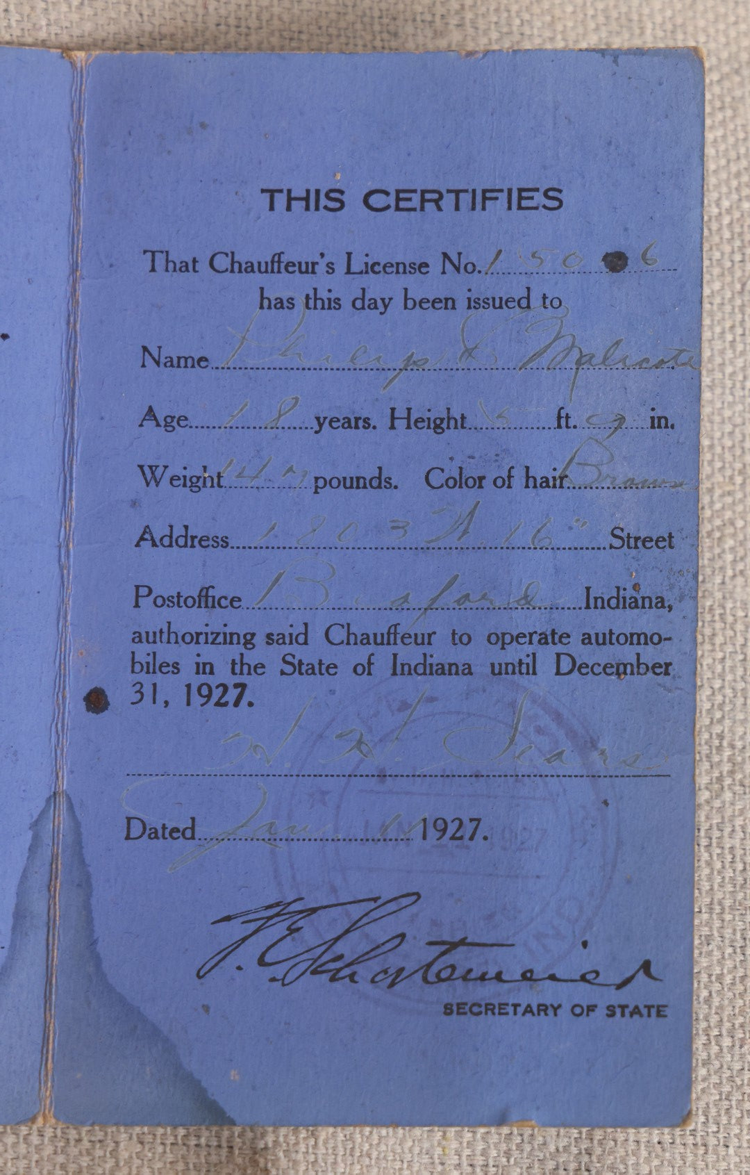 Lot 092 - Vintage 1927 Indiana Chauffeur's License With Circle-Cut Photograph Of Philip C. Malcote, Facsimile Signature Of F. E. Schortemeier, Secretary Of State