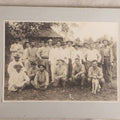 Lot 096 - Antique Board-Mounted Photograph Of A Group Of Men In A Tropical Setting With A Dog