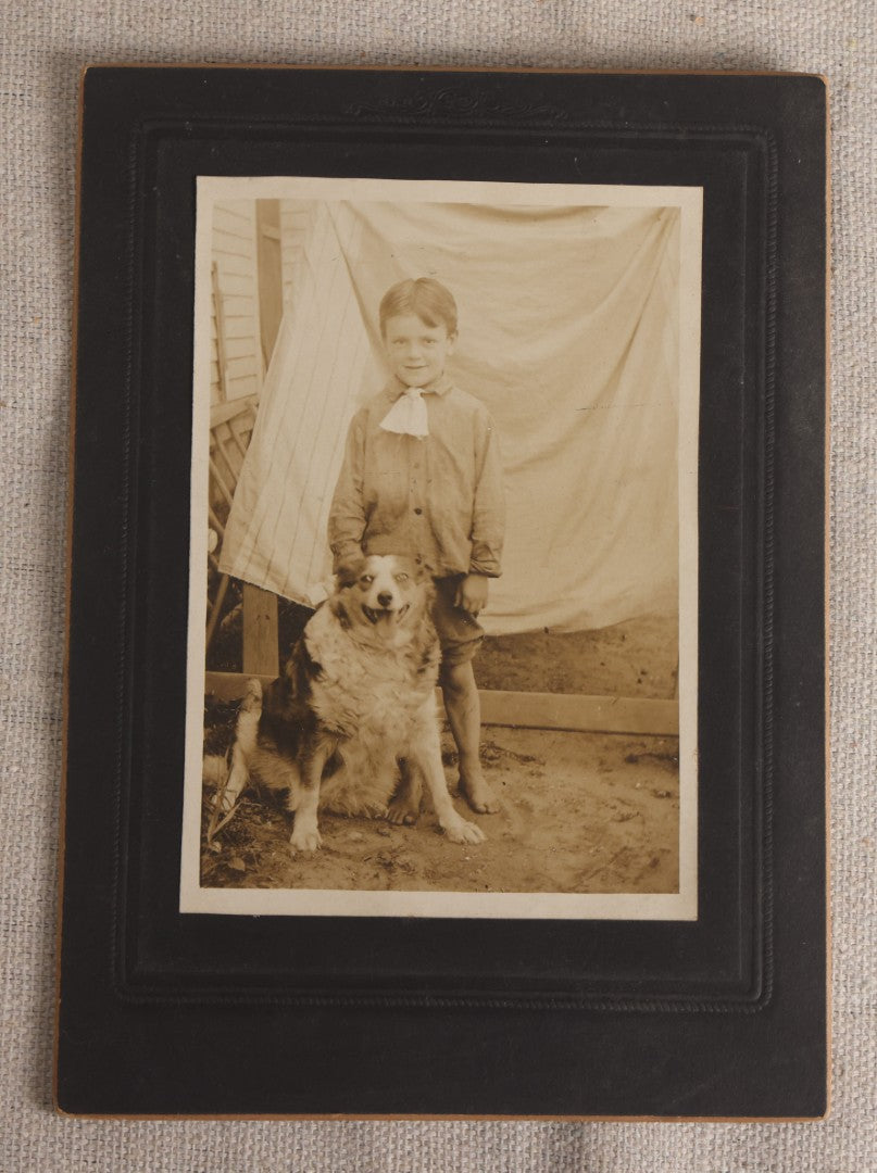 Lot 103 - Antique Board-Mounted Photograph Of A Barefoot Boy With A Dog