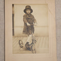 Lot 104 - Antique Board-Mounted Photograph Of A Child On A Kick Scooter With American Flag