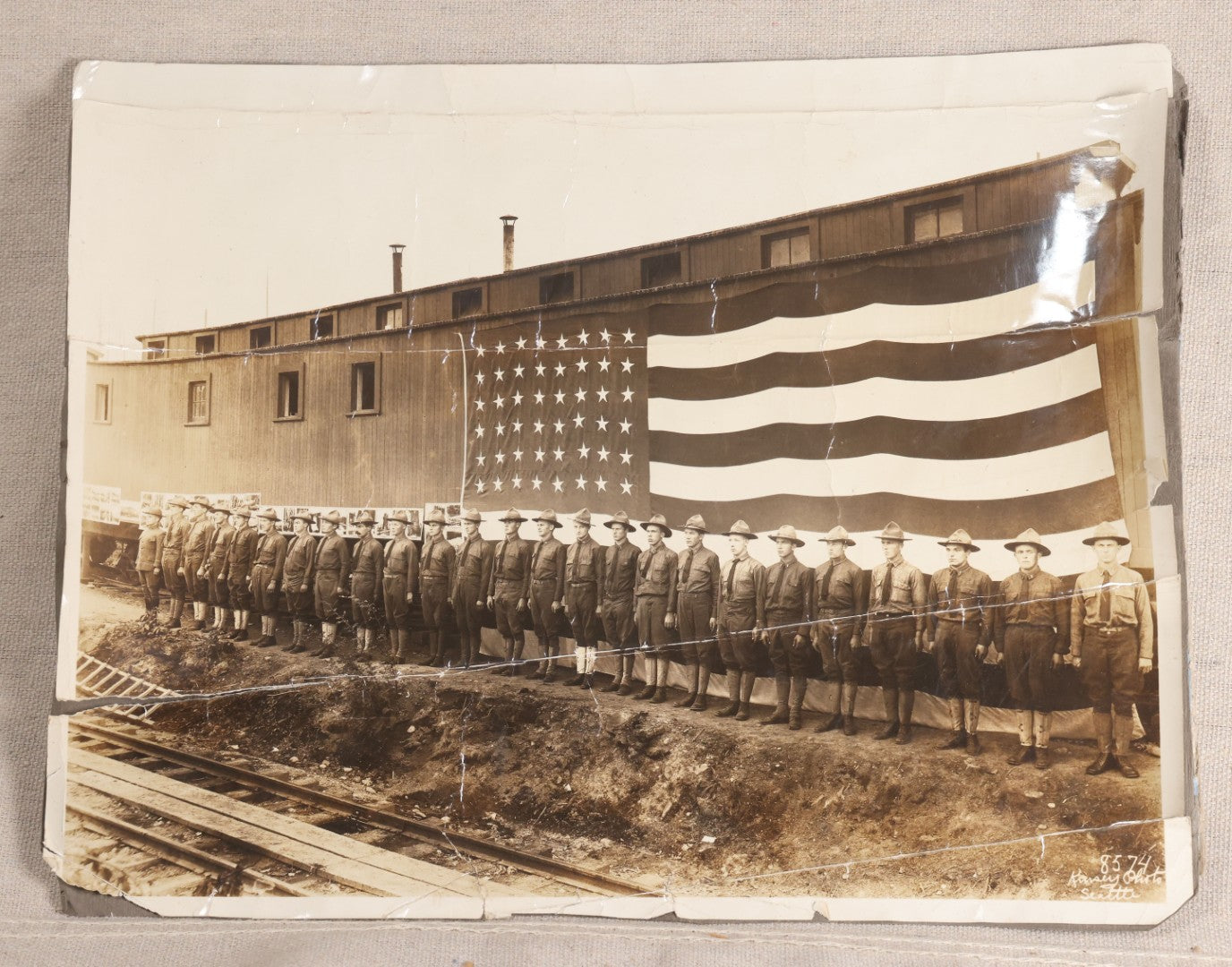 Lot 109 - Antique Board-Mounted Photograph Of World War I Soldiers In Formation Before A Large American Flag, Photographed By Kinsey Photo, Seattle