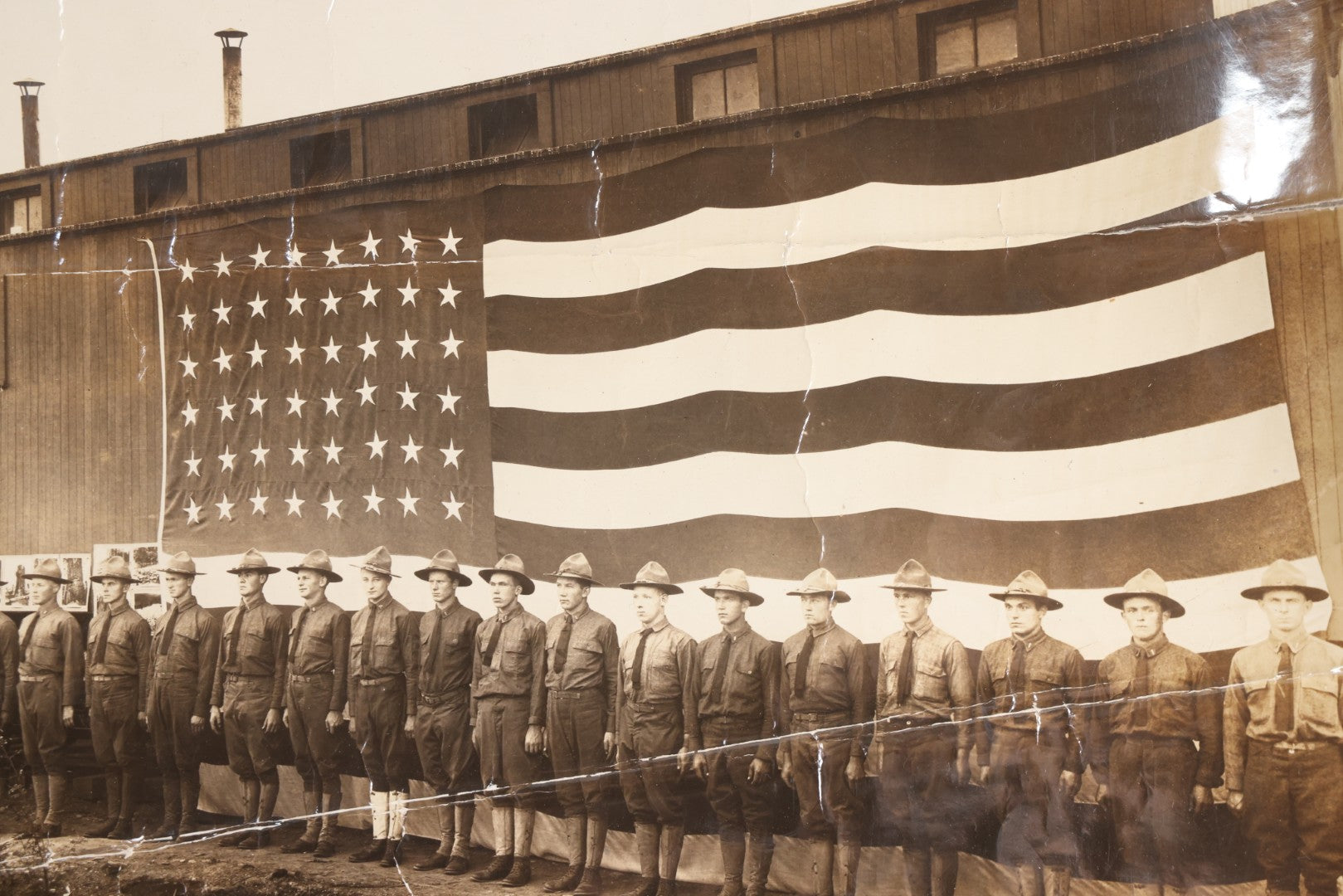 Lot 109 - Antique Board-Mounted Photograph Of World War I Soldiers In Formation Before A Large American Flag, Photographed By Kinsey Photo, Seattle