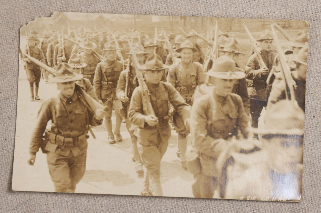 Lot 111 - Grouping Of 25 World War I Era Postcards, Mostly R.P.P.C.., From George F.A. Mulcahy, Including Training Scenes At Plattsburgh And Camp Devens, Barracks Interior, Rifle Training, Map Reading, And Marching