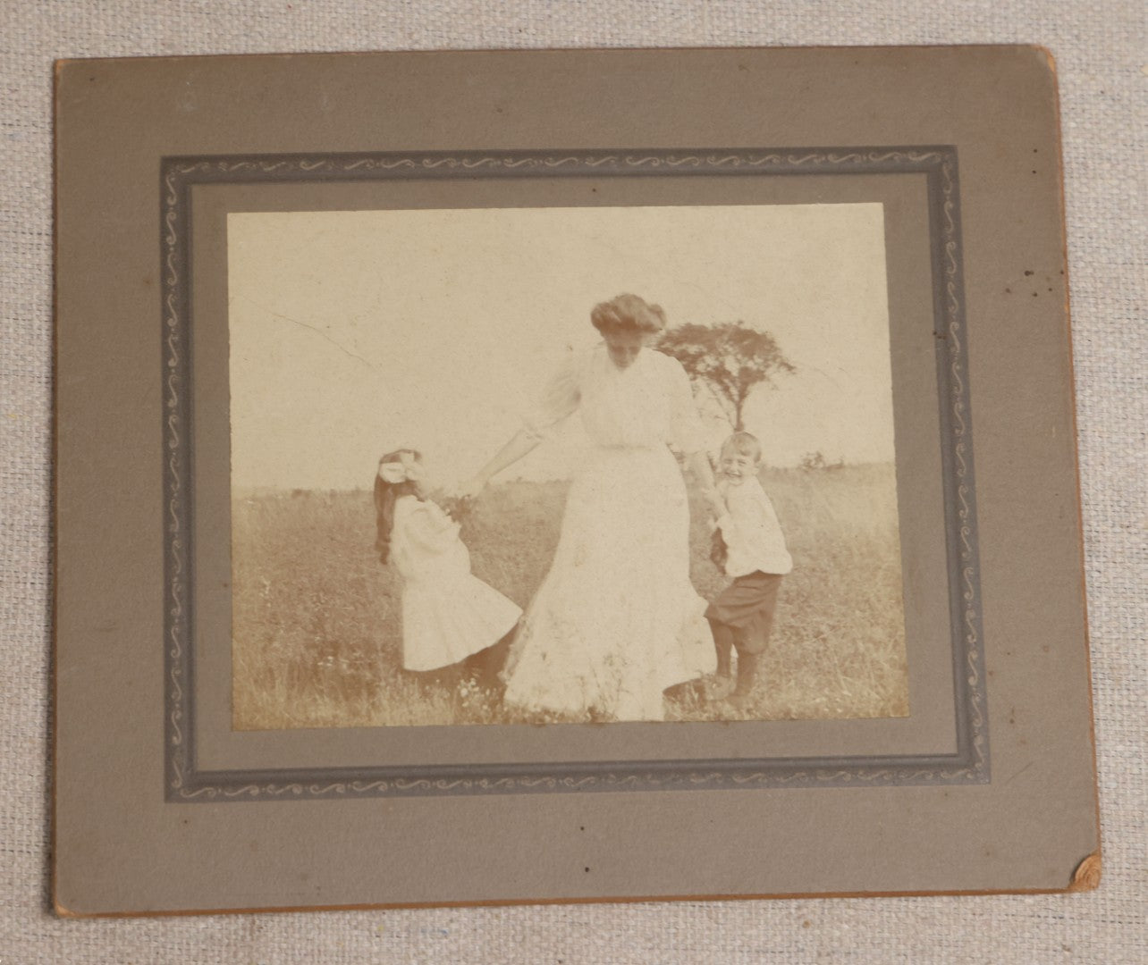 Lot 115 - Grouping Of Six Antique Board-Mounted Photographs Of Children, Including American Flag, Pet Bunnies, Pet Chickens, Doll In Pram, And Winter Sled Scene