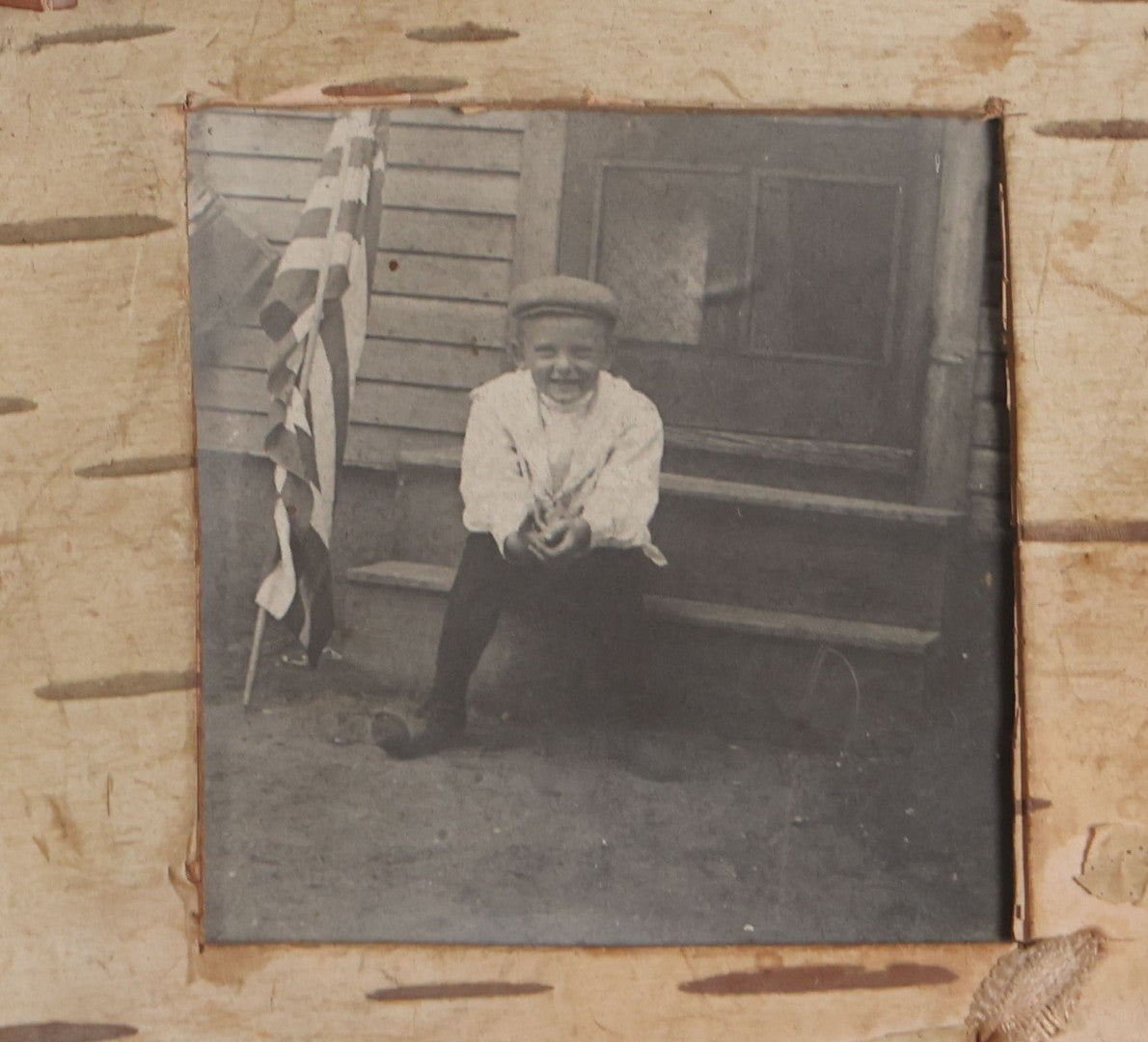 Lot 115 - Grouping Of Six Antique Board-Mounted Photographs Of Children, Including American Flag, Pet Bunnies, Pet Chickens, Doll In Pram, And Winter Sled Scene