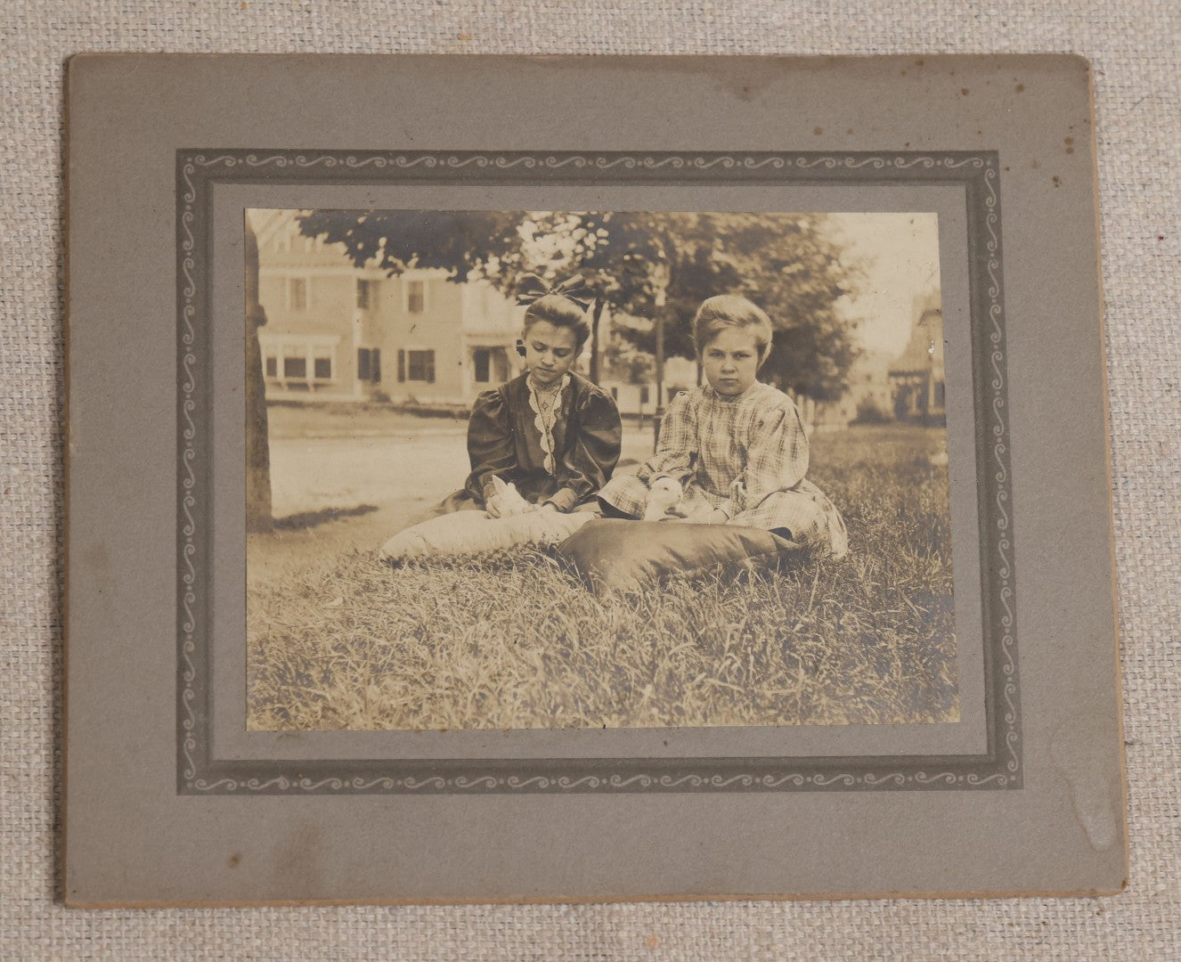 Lot 115 - Grouping Of Six Antique Board-Mounted Photographs Of Children, Including American Flag, Pet Bunnies, Pet Chickens, Doll In Pram, And Winter Sled Scene