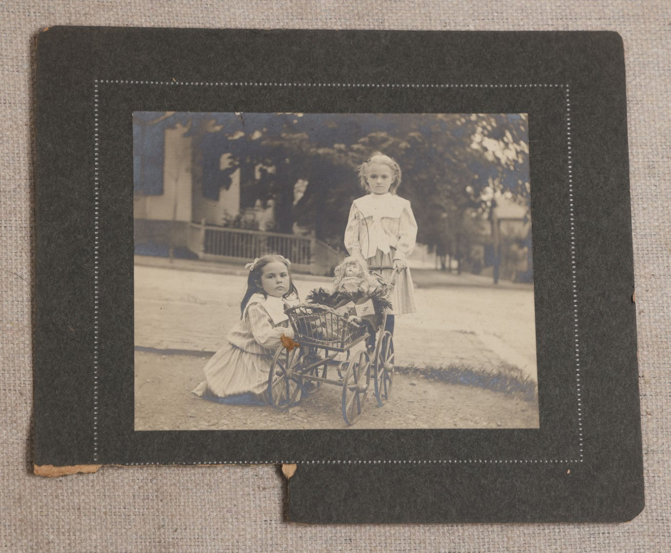 Lot 115 - Grouping Of Six Antique Board-Mounted Photographs Of Children, Including American Flag, Pet Bunnies, Pet Chickens, Doll In Pram, And Winter Sled Scene