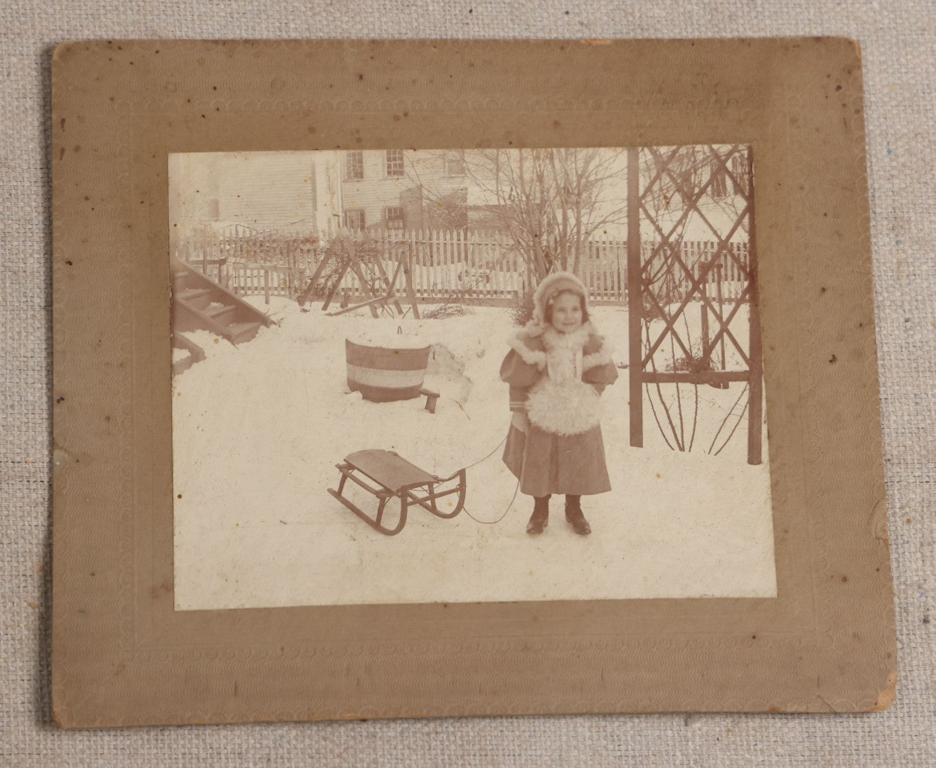 Lot 115 - Grouping Of Six Antique Board-Mounted Photographs Of Children, Including American Flag, Pet Bunnies, Pet Chickens, Doll In Pram, And Winter Sled Scene