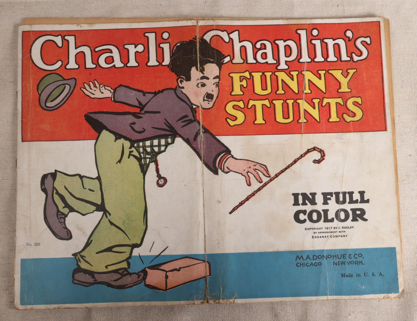 Lot 123 - "Charlie Chaplin's Funny Stunts" Antique Color Illustrated Comic Book, No. 380, Published By M. A. Donohue & Co., Chicago And New York, 1917, Note Large Fold Through Center