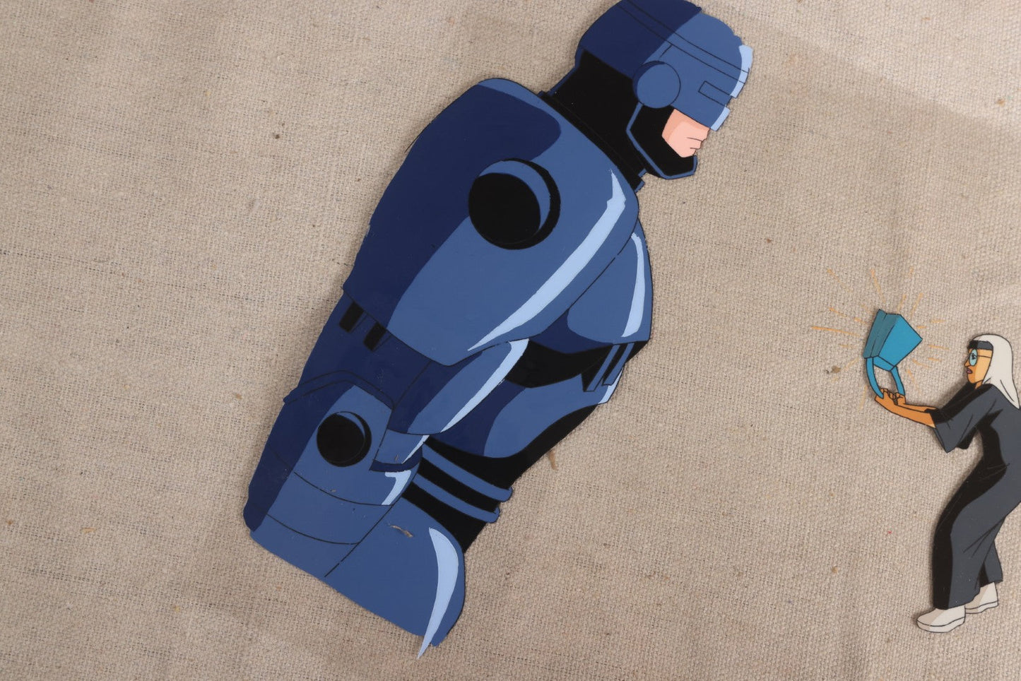 Lot 127 - Grouping Of Eight Vintage "Robocop: Alpha Commando" Production Animation Ephemera, Including Five Animation Cels, Production Sketch Drawing, Background, And Dope Sheet, 1998-1999, M.G.M. Animation