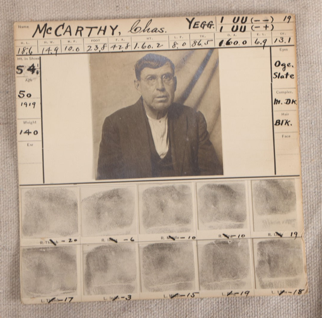 Lot 154 - Antique Real-Photo Police Mugshot And Arrest Card For Chas. McCarthy, Alias Chas. H. McKay, Yeggman, Criminal Specialty Safe Blower, Robbed Tremont Maine Savings Bank, Hancock County Maine Jail, 1919, With Fingerprints And Newspaper Clipping