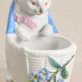 Lot 172 - Antique Porcelain Figural Cat With Basket Vase, White Cat Wearing Blue Bow And Pink Scarf With Applied Floral Decoration, Likely German, 5-1/4" Height