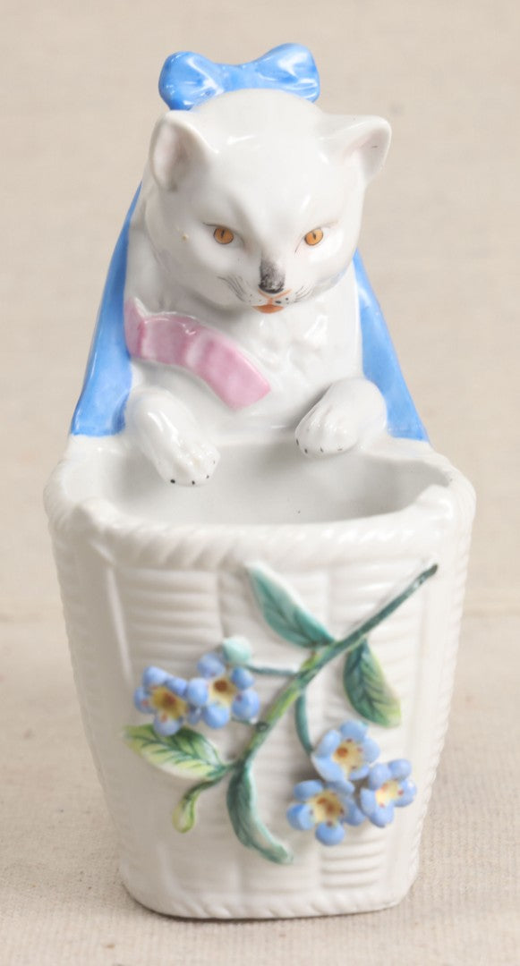 Lot 172 - Antique Porcelain Figural Cat With Basket Vase, White Cat Wearing Blue Bow And Pink Scarf With Applied Floral Decoration, Likely German
