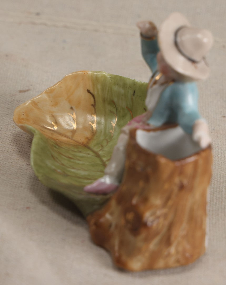 Lot 176 - Antique Porcelain Figural Match Safe And Ashtray With Boy Seated On A Tree Stump And Leaf-Form Tray