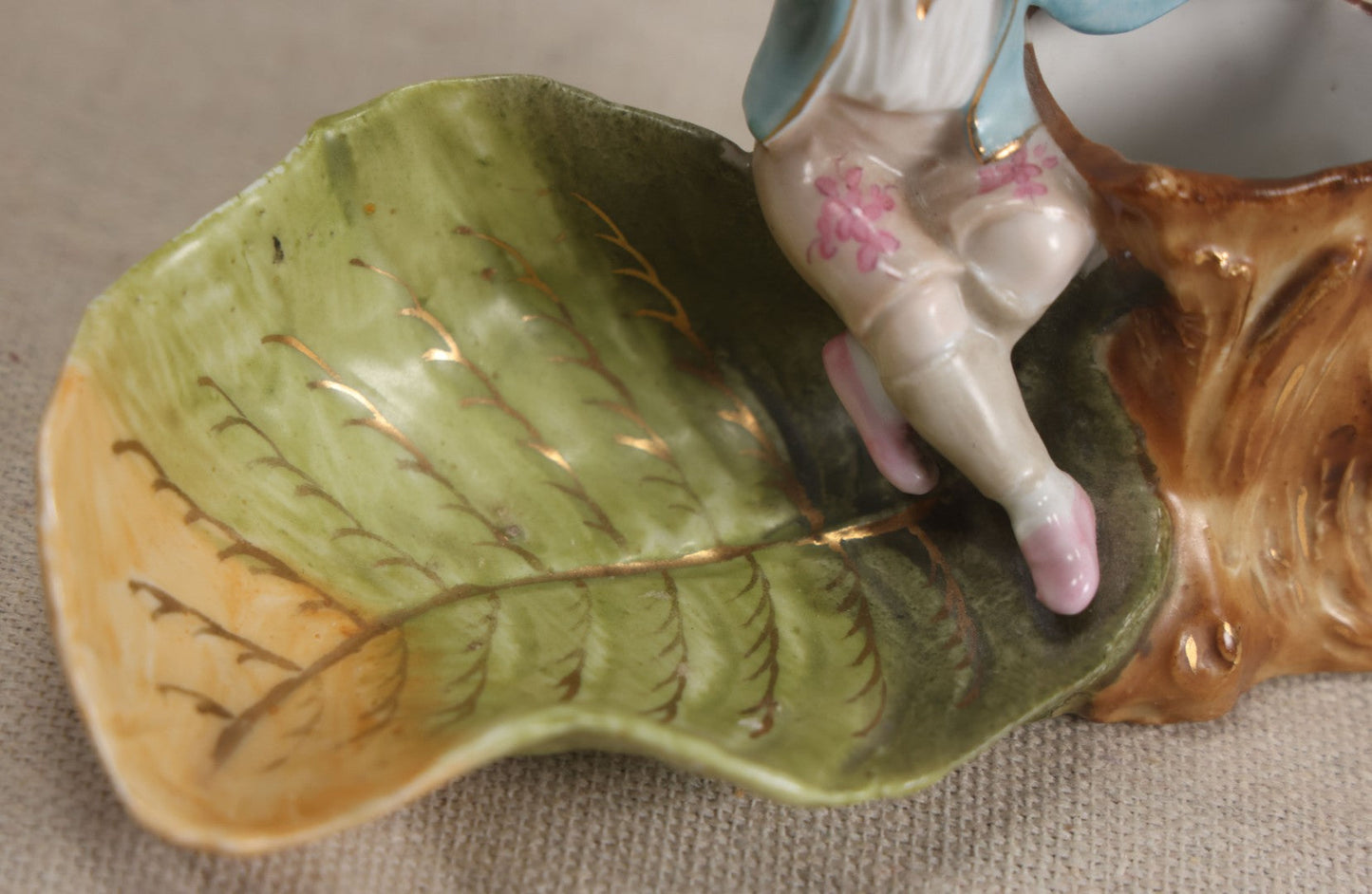 Lot 176 - Antique Porcelain Figural Match Safe And Ashtray With Boy Seated On A Tree Stump And Leaf-Form Tray
