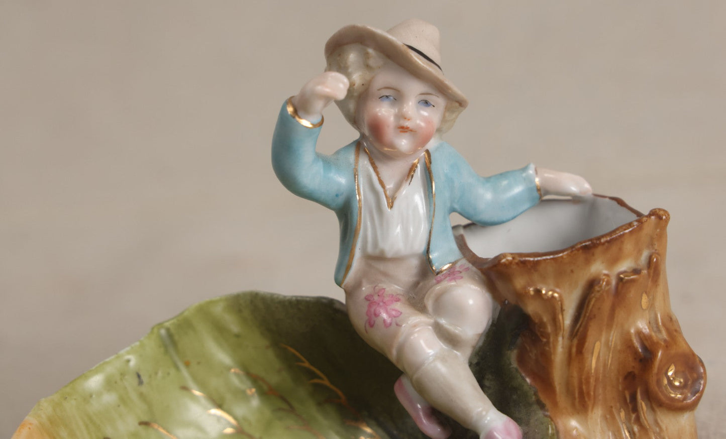 Lot 176 - Antique Porcelain Figural Match Safe And Ashtray With Boy Seated On A Tree Stump And Leaf-Form Tray