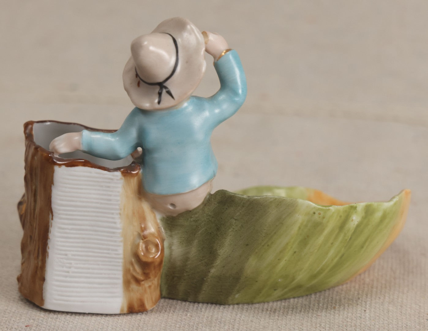 Lot 176 - Antique Porcelain Figural Match Safe And Ashtray With Boy Seated On A Tree Stump And Leaf-Form Tray