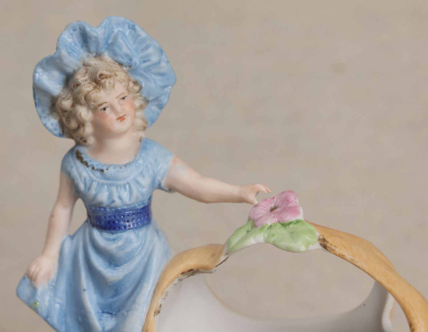 Lot 177 - Antique Bisque Figural Vase With Girl In Blue Dress Beside A Flower-Adorned Basket, Likely German
