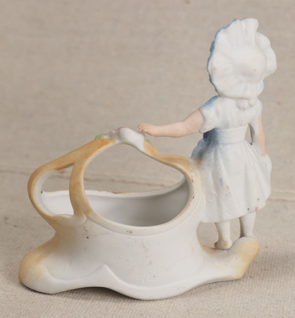 Lot 177 - Antique Bisque Figural Vase With Girl In Blue Dress Beside A Flower-Adorned Basket, Likely German