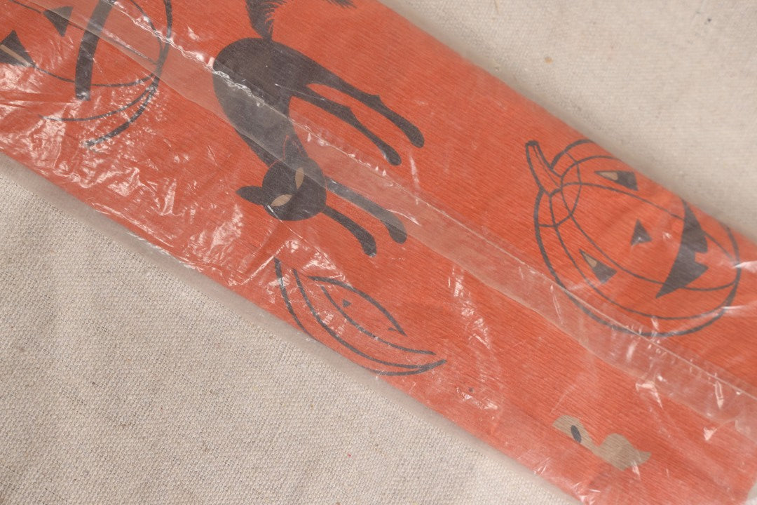 Lot 188 - Vintage Orange Dennison Halloween Flame Proof Crepe Paper With Black Cat, Jack-O-Lantern, And Gray Ghost Graphics In Original Packaging