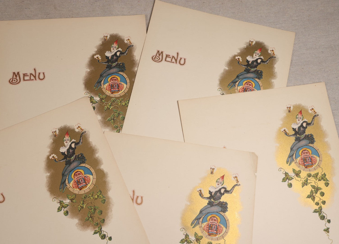 Lot 191 - Grouping Of Five Antique Blank Menu Sheets With "Biere Du Lion" ("Lion Beer") Beer Advertising Graphic, Clown Figure With Beer Glasses And Hop Vine, Plus One Additional Sheet With Losses