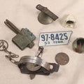 Lot 238 - Grouping Of Seven Vintage Mixed Metal Items Including Oneida Jump Animal Trap No. 1 By Animal Trap Co., Lititz, Pennsylvania, Perko Marine Fitting, Fonda Del Corro Key Tag, And More