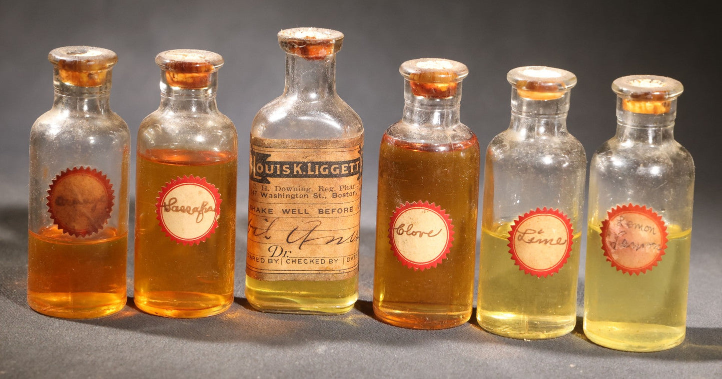 Lot 018 - Grouping Of Six Vintage Glass Flavoring Oil Extract Bottles With Contents Including Anise, Lemon, Lime, Clove, Orange, And Sassafras