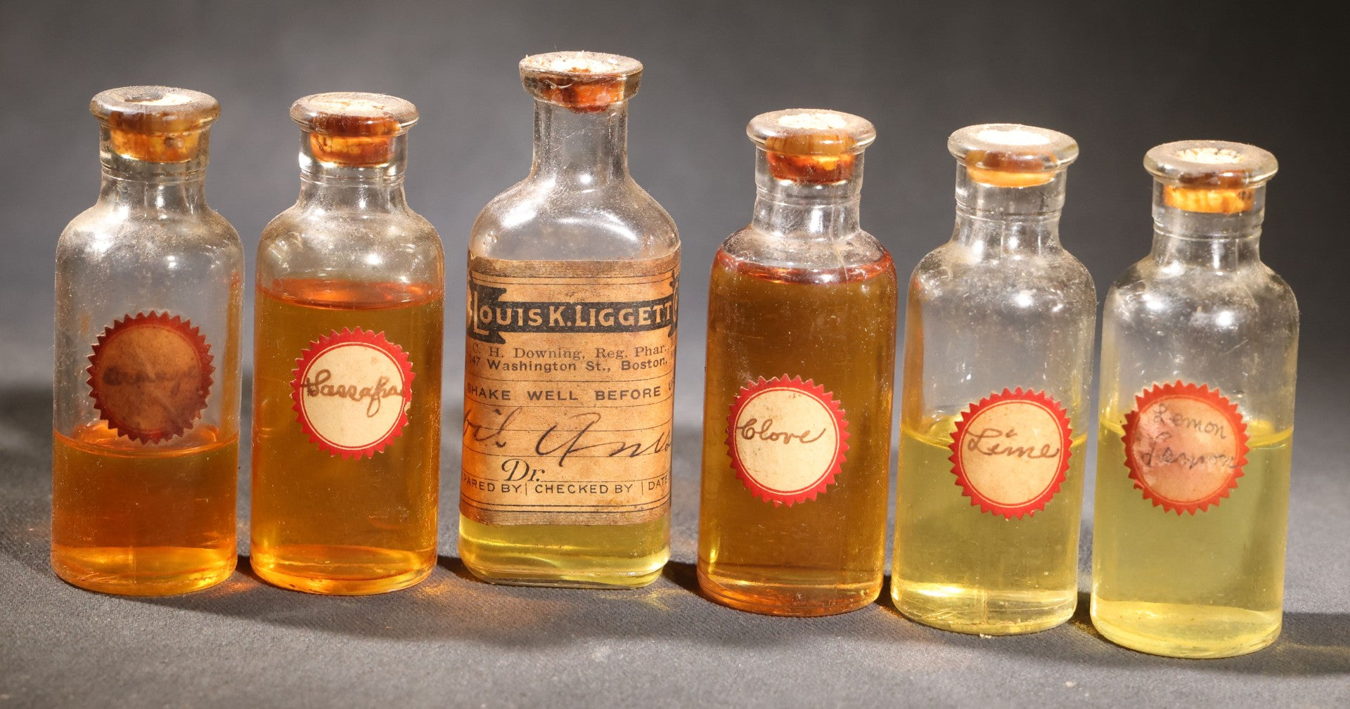 Lot 018 - Grouping Of Six Vintage Glass Flavoring Oil Extract Bottles With Contents Including Anise, Lemon, Lime, Clove, Orange, And Sassafras