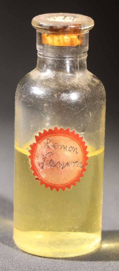Lot 018 - Grouping Of Six Vintage Glass Flavoring Oil Extract Bottles With Contents Including Anise, Lemon, Lime, Clove, Orange, And Sassafras