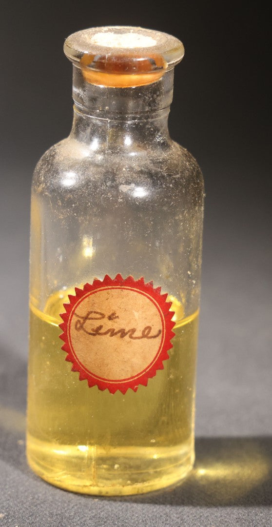 Lot 018 - Grouping Of Six Vintage Glass Flavoring Oil Extract Bottles With Contents Including Anise, Lemon, Lime, Clove, Orange, And Sassafras