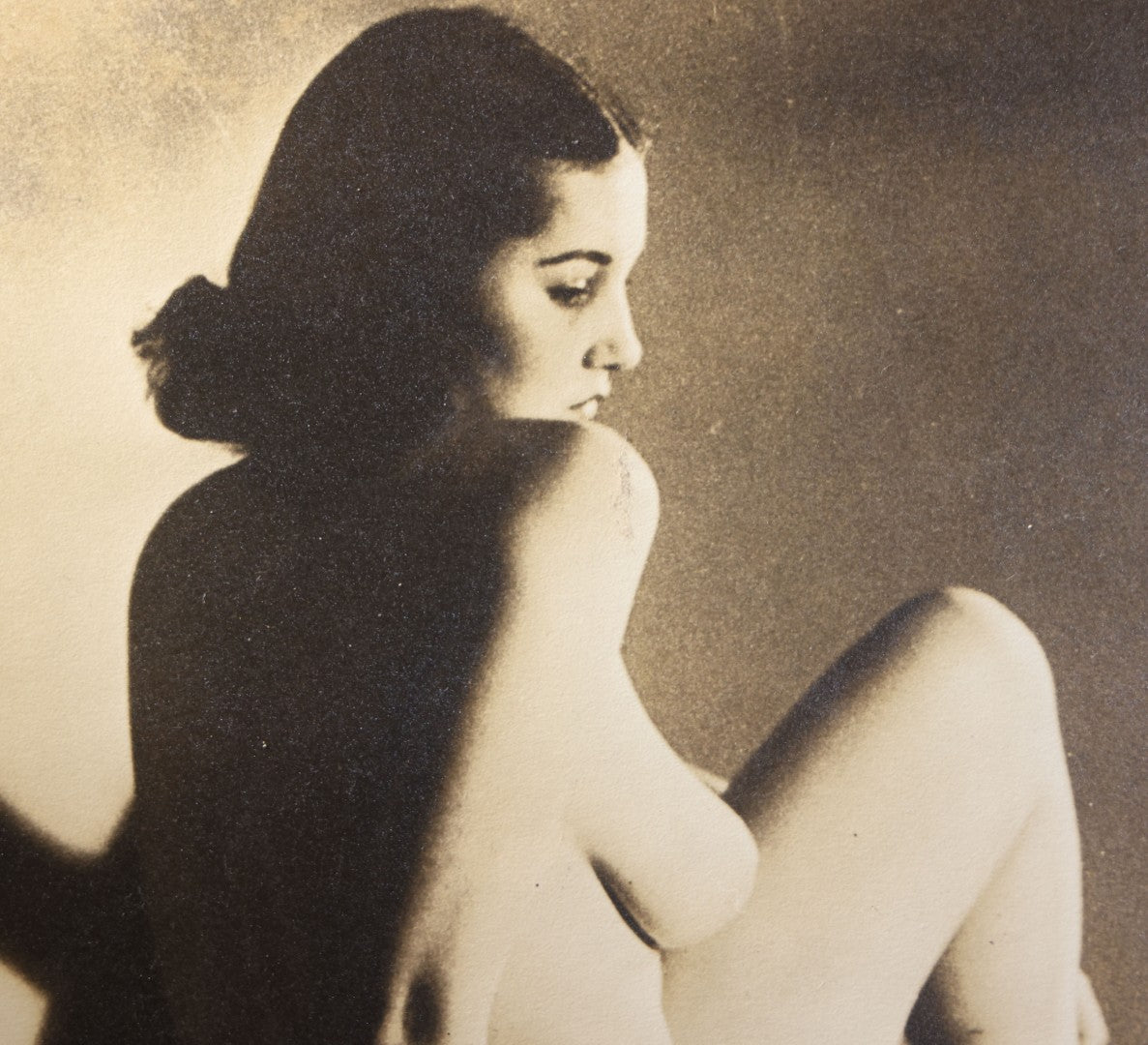 Lot 025 - Antique Framed Sepia-Tone Art Nude Photograph Of A Seated Young Woman With Dramatic Shadow, Circa 1920s-1930s