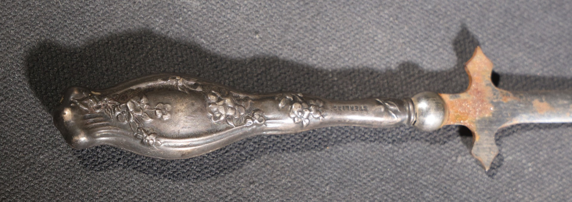 Lot 029 - Antique Sterling Silver-Handled Sword-Form Letter Opener With Floral Repousse Handle And Cross Guard