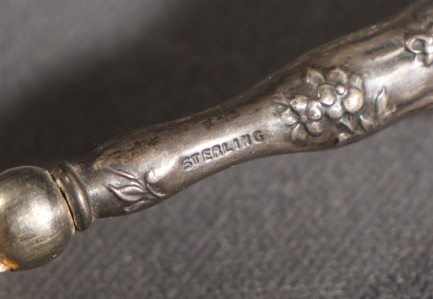 Lot 029 - Antique Sterling Silver-Handled Sword-Form Letter Opener With Floral Repousse Handle And Cross Guard