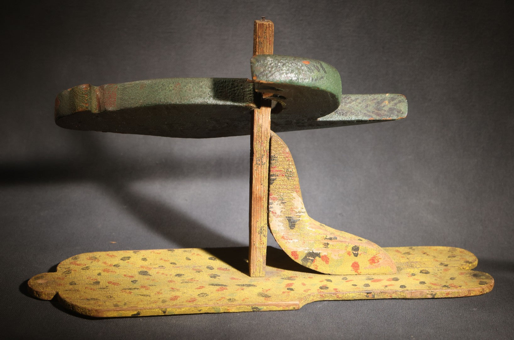 Lot 035 - Antique Folk Art Painted Green Scroll-Cut Wooden Wall-Mounted Parrot On Yellow Spatter-Painted Backboard