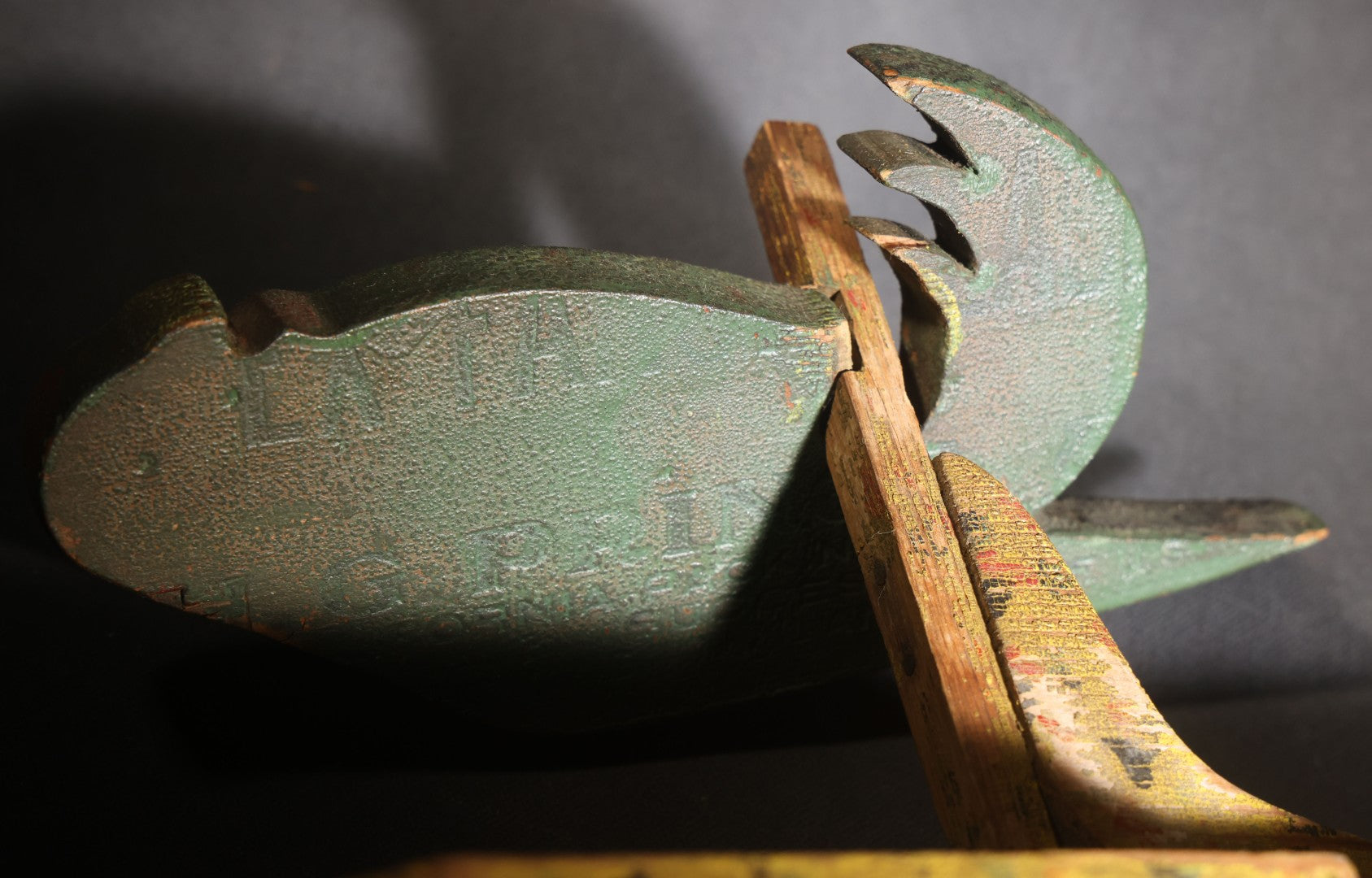 Lot 035 - Antique Folk Art Painted Green Scroll-Cut Wooden Wall-Mounted Parrot On Yellow Spatter-Painted Backboard