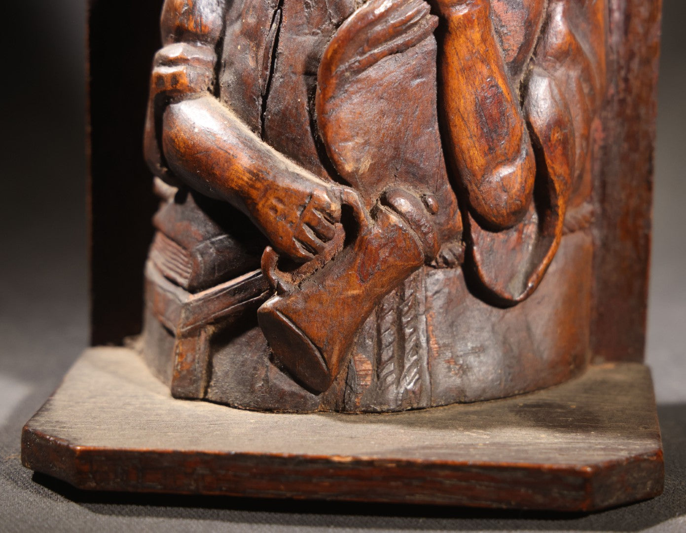 Lot 037 - Antique Folk Art Hand-Carved Wooden Figural Sculpture Of A Laughing Man With A Stein, Leaning On Books