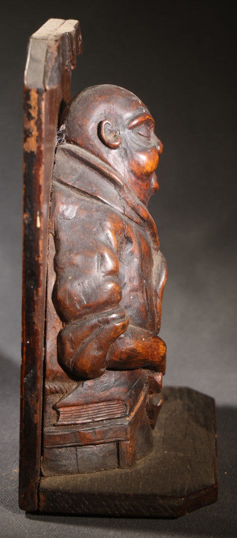 Lot 037 - Antique Folk Art Hand-Carved Wooden Figural Sculpture Of A Laughing Man With A Stein, Leaning On Books
