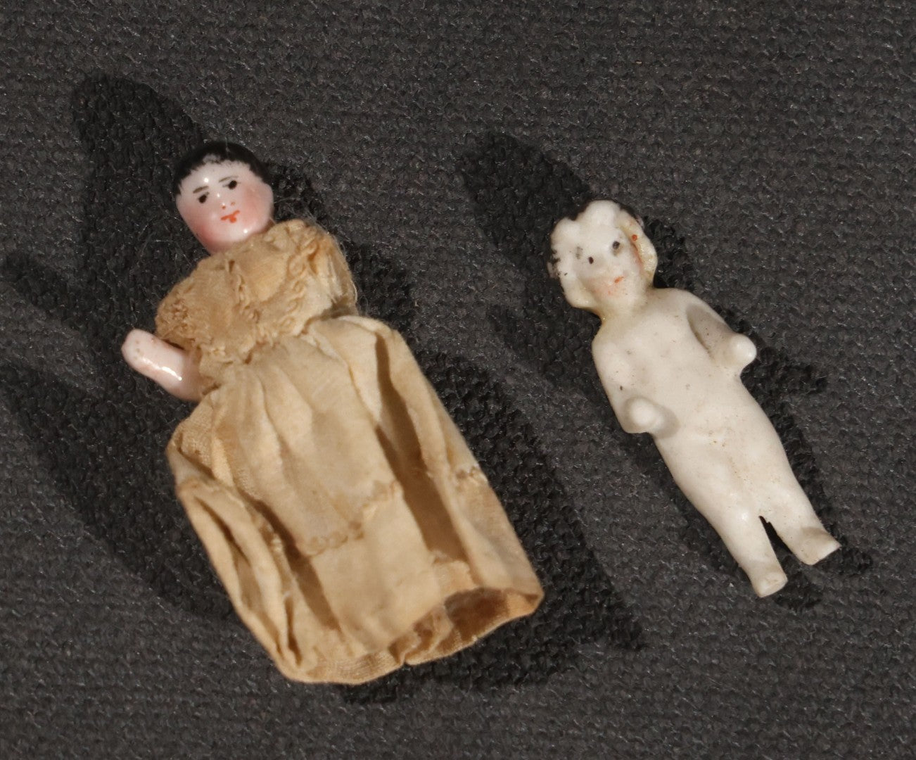 Lot 045 - Pair Of Antique Miniature Frozen Charlotte Dolls, One Porcelain In Cloth Gown And One Bisque