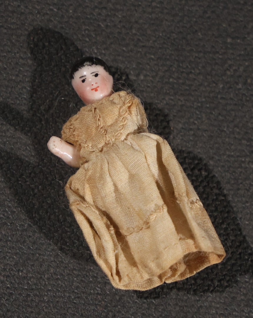 Lot 045 - Pair Of Antique Miniature Frozen Charlotte Dolls, One Porcelain In Cloth Gown And One Bisque